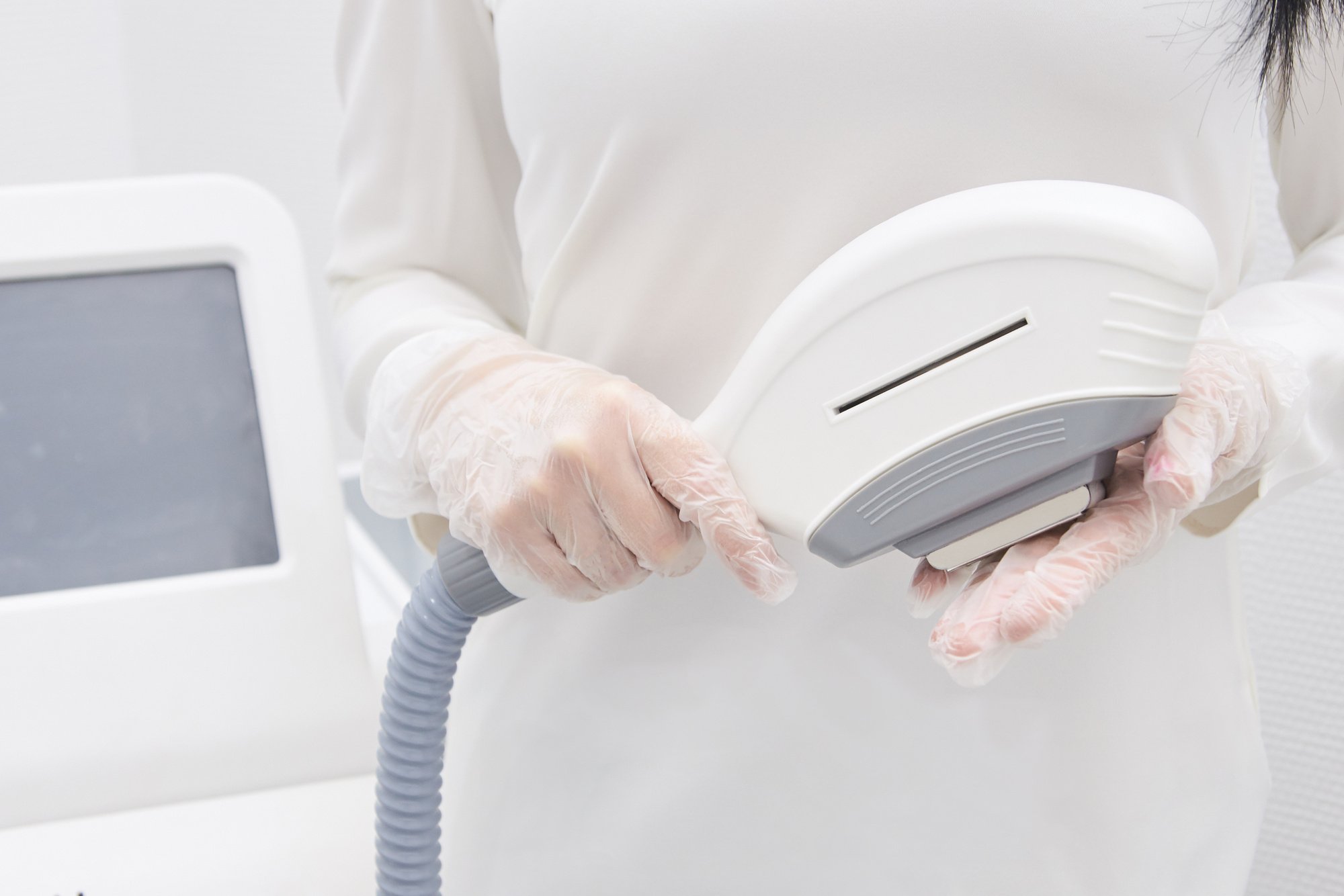 Woman Holding a Laser Hair Removal Equipment